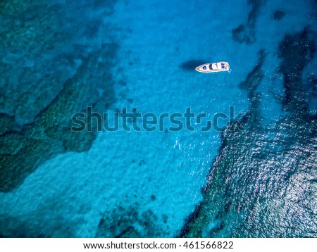 Aerial view of tropical island beach holiday yacht on blue reef ocean
