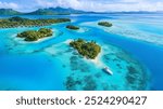 Aerial view of a tropical lagoon with turquoise water and small islands in Bora Bora, French Polynesia.