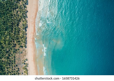 Aerial view to tropical sandy beach and blue ocean. Top view of ocean waves reaching shore on sunny day. Palawan, Philippines. - Powered by Shutterstock