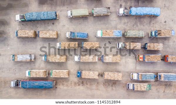 Aerial view of \
trucks transporting the\
timber.