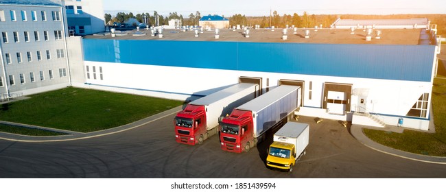 Aerial view of trucks unloading in logostics center.
