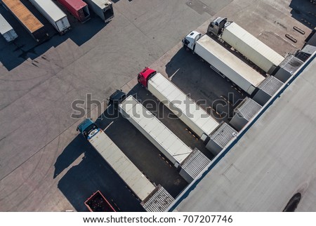 Aerial view of trucks unloading in logostics center