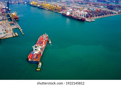 Aerial view Tugboat pushing container ship to quayside for load and unload container via crane for logistics, import export goods internationally around the world, including Asia Pacific and Europe,
