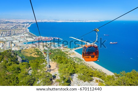 Aerial view from Tunektepe Cableway of beautiful blue Gulf of Antalya and popular seaside resort city Antalya, Turkey. Sunny day, high mountains on horizon. Stock photo © 