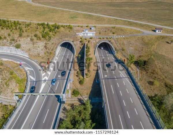 Aerial\
view of tunnel entrance of highway in\
Switzerland
