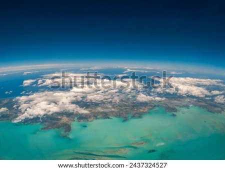 An aerial view of the Turks and Caicos Islands from an airplane window