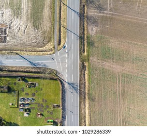 Aerial view of the turn off to the left of a country road in Germany. Abstract impression due to vertical angle of view. Made with drone