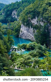 Aerial View At Turquoise Lakes With Wooden Hiking Path Through Water Besides Waterfalls In Plitvice Lakes National Park, Croatia