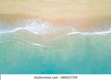 Aerial view of turquoise ocean wave reaching the coastline. Beautiful tropical beach from top view. Andaman sea in Thailand. Summer holiday vacation concept - Shutterstock ID 1404217199