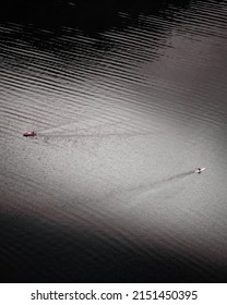 An Aerial View Of Two Boats Swimming In The Calm Water