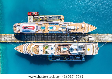 Aerial view of two giant cruise ships moored in the port of Philipsburg along with three barges, island of Sint Maarten, Dutch Antilles, West Indies, Caribbean.