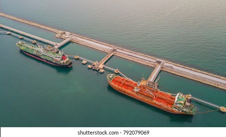 Aerial view two tanker ship at the port terminal, oil terminal is industrial facility for storage of oil and petrochemical products ready for transport to further storage facilities.