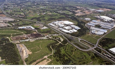 Aerial View Of A Typical Highway Exits And Overpass Near An Industrial And Commercial Area In Australia