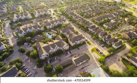 Aerial View Of Typical Multi-level Apartment Building With Swimming Pool, Surrounded By Green Garden And Rows Of Cars In Parking Lots In Houston, Texas, US. Residential Recreation Concept. Warm Light.