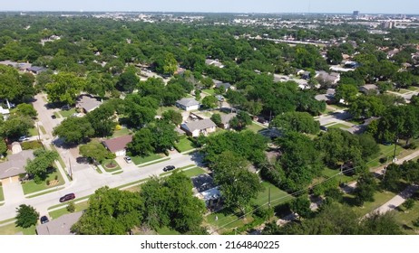 Aerial View Typical Residential Neighborhood Surrounded By Park And Lush Green Trees With Downtown Buildings In Background In Richardson, Texas, USA. North Texas Subdivision And Urban Sprawl