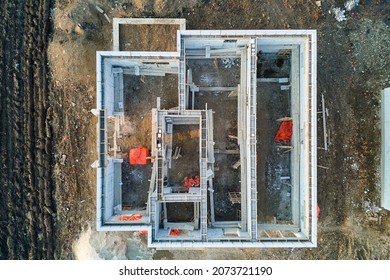 Aerial View Of Unfinished Frame Of Private House Foundation Under Construction.