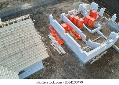 Aerial View Of Unfinished Frame Of Private House Foundation Under Construction.