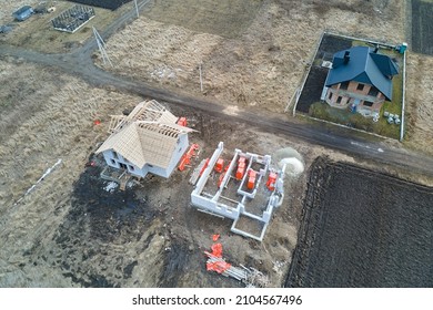 Aerial View Of Unfinished Frame Of Private House Foundation Under Construction.