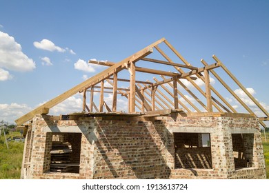 Aerial View Of Unfinished House With Wooden Roof Frame Structure Under Construction.