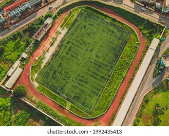 Aerial View Of University Of Nigeria Nsukka Showing A Football Field, Close View Of Hostels And Office Buildings.