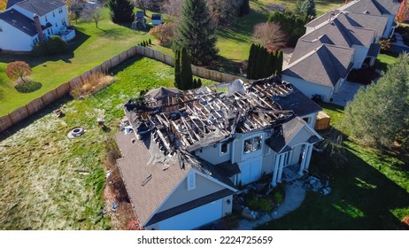 Aerial view upscale residential neighborhood with burnt house between other two story homes in Rochester, New York. Property totally damaged by fire disaster, insurance claim background - Shutterstock ID 2224725659