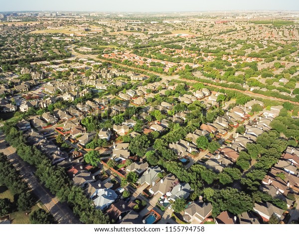 Aerial view urban sprawl near downtown Dallas,\
Texas, USA. Suburban tightly packed homes neighborhood with\
driveways, apartment building complex flyover. Vast suburbia\
subdivision in Irving, Texas,\
US