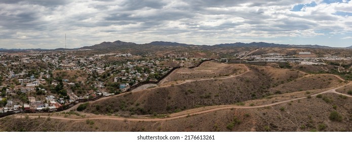 Aerial View Of US Mexico Border Fence In Nogales, Arizona. Drone Panorama. 