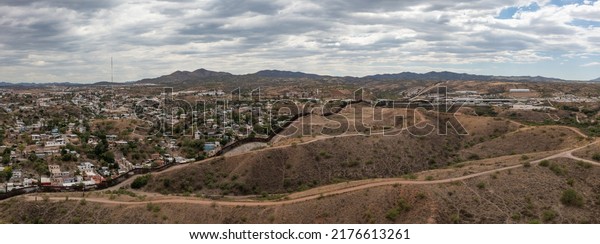 Aerial view of US Mexico Border fence in Nogales,\
Arizona. Drone panorama.\
