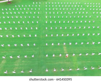 Aerial View Of US Military Cemetery In Houston, Texas, US. Endless Row Of White Marble Gravestones, Grave Markers With Flags And Flowers On Memorial Day To Honor Fallen Heroes In War, Military Service