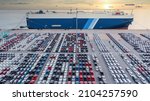 Aerial view vehicle carrier vessel loading car for shipping to worldwide, Large RoRo (Roll on off) vehicle car carrier, New car lined up in the port for import export around the world.