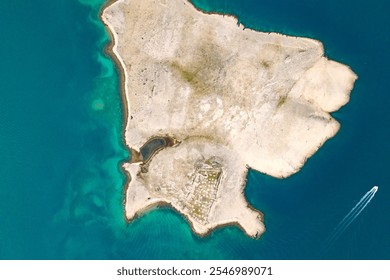 Aerial view of Veli Sikavac island, Croatia near the Pag island. The contrast of clear turquoise water of Adriatic Sea and the winding rocky coastline of the island. Concept travel in Croatia - Powered by Shutterstock