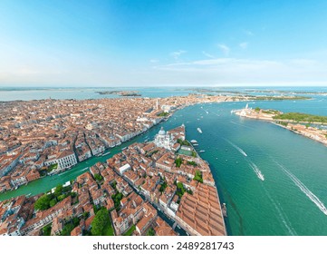 An aerial view of Venice, Italy showcasing its canals, historic buildings, and the surrounding lagoon under a clear blue sky. - Powered by Shutterstock