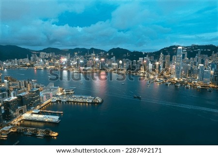Aerial view of Victoria Harbor of Hong Kong city at dusk 