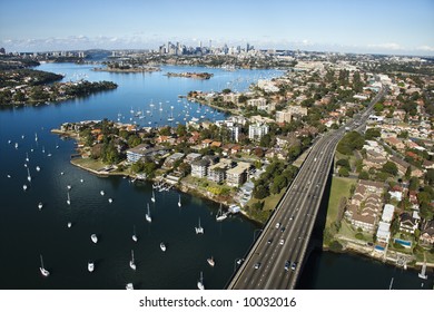 Aerial View Of Victoria Road Bridge And Boats With Distant Downtown Skyline In Sydney, Australia.