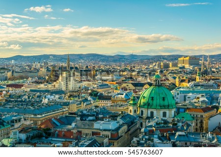 Aerial view of Vienna with tower of the town hall building, votivkirche and peterskirche churches from the stephansdom cathedral.