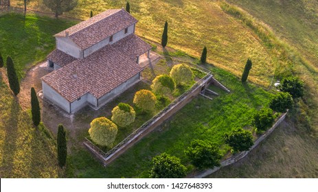 Aerial View Of A Villa At Sunset. The Country House Has A Large Garden With Trees And Plants And Is Surrounded By Nature In The Hills Of Tuscany, Italy. 