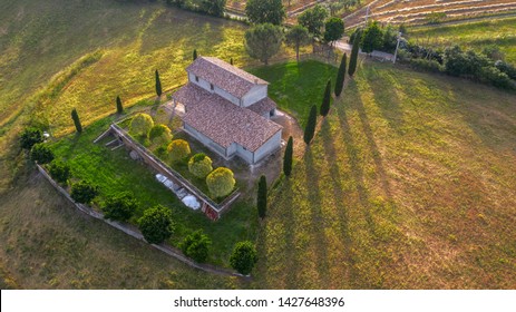 Aerial View Of A Villa At Sunset. The Country House Has A Large Garden With Trees And Plants And Is Surrounded By Nature In The Hills Of Tuscany, Italy. 