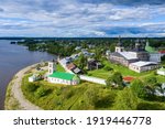 Aerial view of Voskreensky Goritsky Monastery and Sheksna river on sunny summer day. Goritsy, Vologda Oblast, Russia.