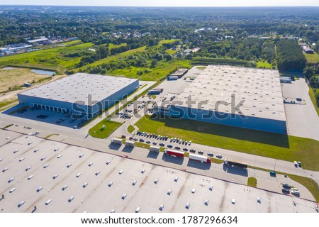 Aerial view of warehouse storages or industrial factory or logistics center from above. Aerial view of industrial buildings and equipment at sunset, toned