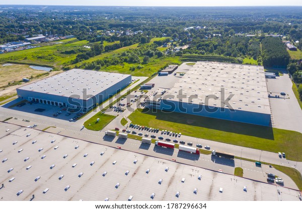 Aerial view of warehouse\
storages or industrial factory or logistics center from above.\
Aerial view of industrial buildings and equipment at sunset,\
toned