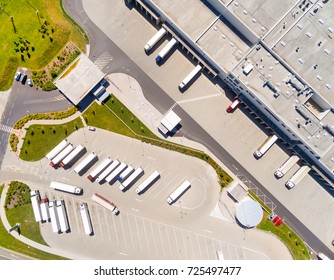 Aerial View Of Warehouse With Trucks. Industrial Background. Logistics From Above. 