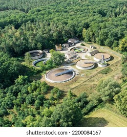 Aerial View Of A Wastewater Treatment Plant With Clarifier, Aeration Basin, Sedimentation Basin, And Secondary Clarifier In An Agricultural Setting.