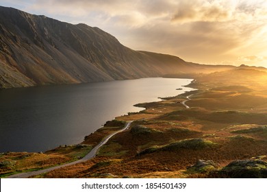 Aerial View Of Wastwater Lake In The English Lake District With Rural Road Leading Through The Landscape.