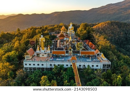 Aerial view of Wat Phrathat Doi Kham, Buddha pagoda and golden chedi in Chiang Mai, Thailand