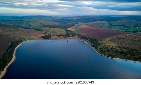 Aerial View Of A Water Reservoir At Dusk, With A Colourful Sky.