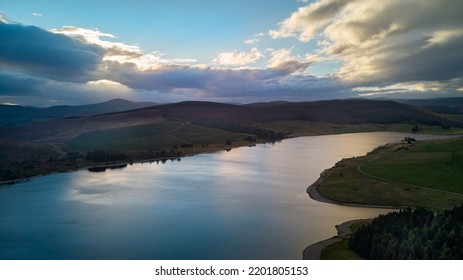 Aerial View Of A Water Reservoir At Night With A Colourful Sky.