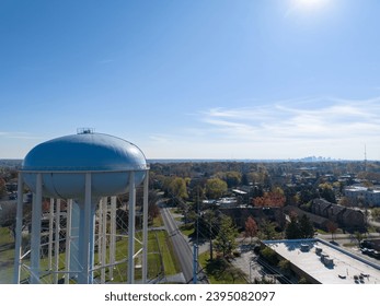 Aerial view of a water tower in Upper Arlington, OH, with Columbus skyline on the horizon.