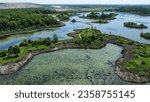 An aerial view of watersheds with a road on a sunny day