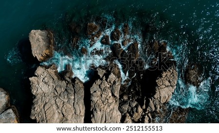 Aerial Drone View Of Dramatic Ocean Waves Crushing On Rocky Landscape