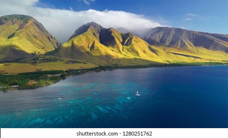 Aerial view of the west coast of Maui with visible coral reef and green mountain on the background. Area of Olowalu, Hawaii